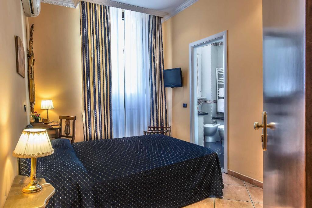 Postel nebo postele na pokoji v ubytování Hotel Caracciolo