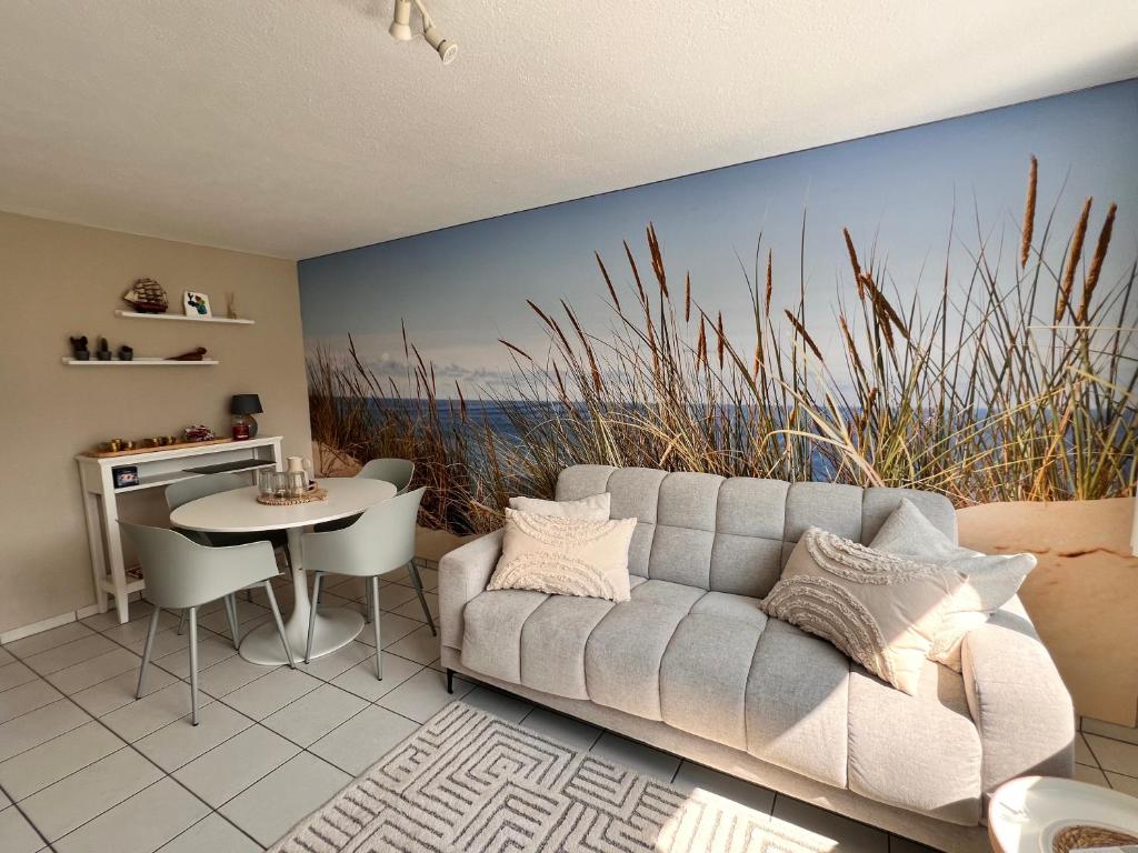 a living room with a couch and a table at Ferienwohnung SUN SAND SEA in Horn