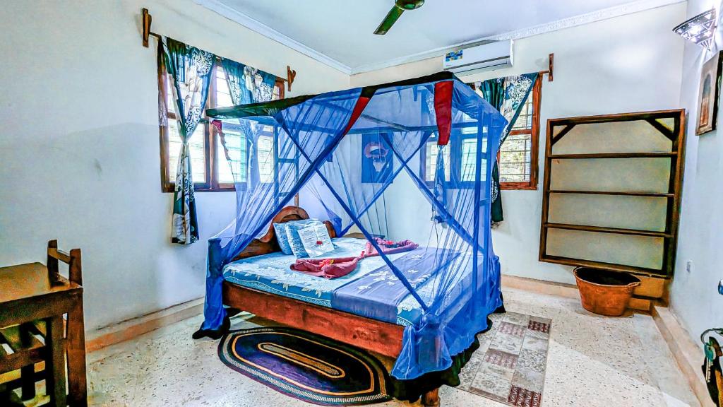 Postel nebo postele na pokoji v ubytování Mwana House