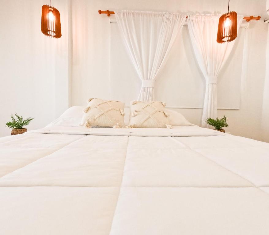 Postel nebo postele na pokoji v ubytování Puesta del Sol Guest House