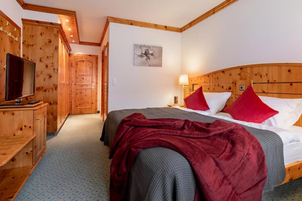 Postel nebo postele na pokoji v ubytování AROSA ALPINE CLUB - Adults only