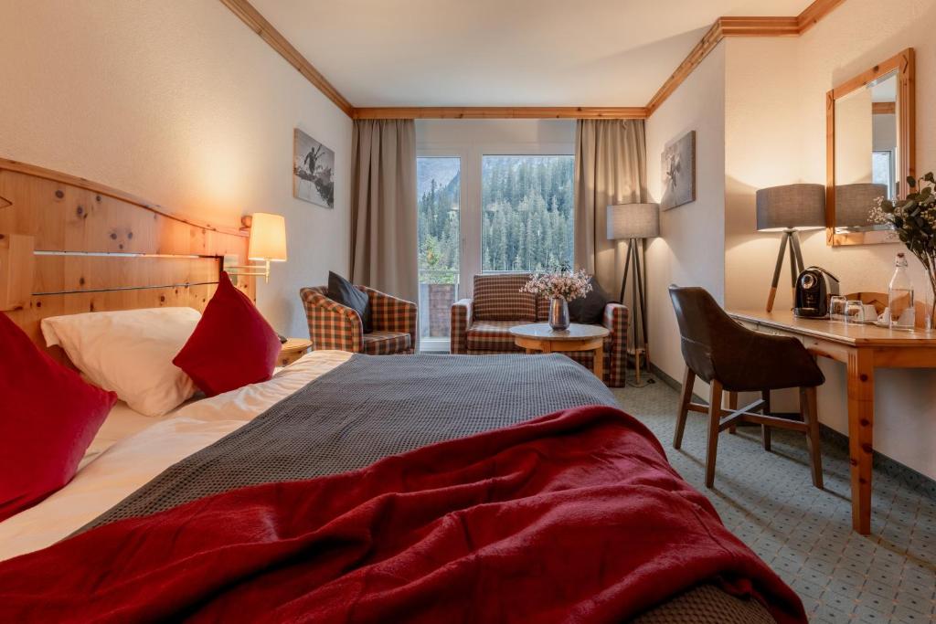 Postel nebo postele na pokoji v ubytování AROSA ALPINE CLUB - Adults only