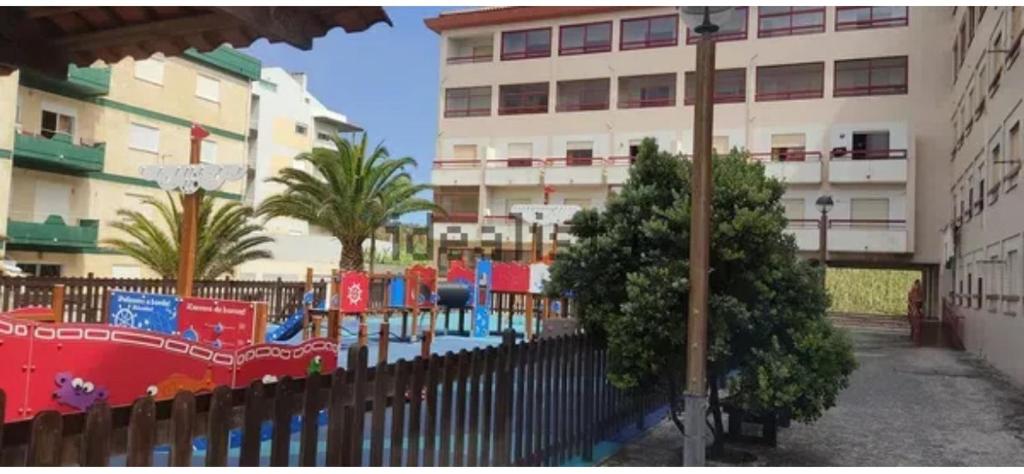 a playground in front of a building at Apartamento F.A in Pedrógão