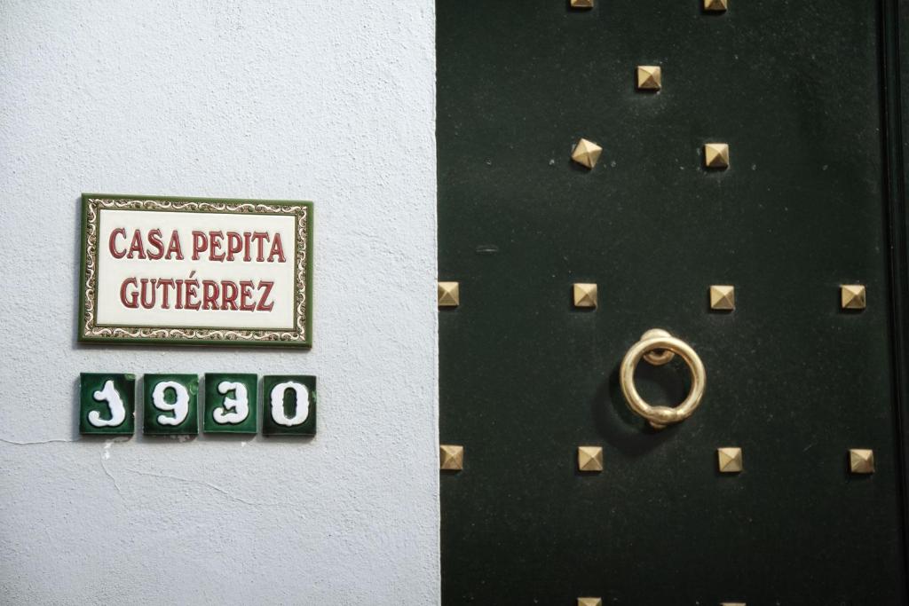 a door with a sign on it with a ring on it at Casa Rural Pepita Gutiérrez in Beas