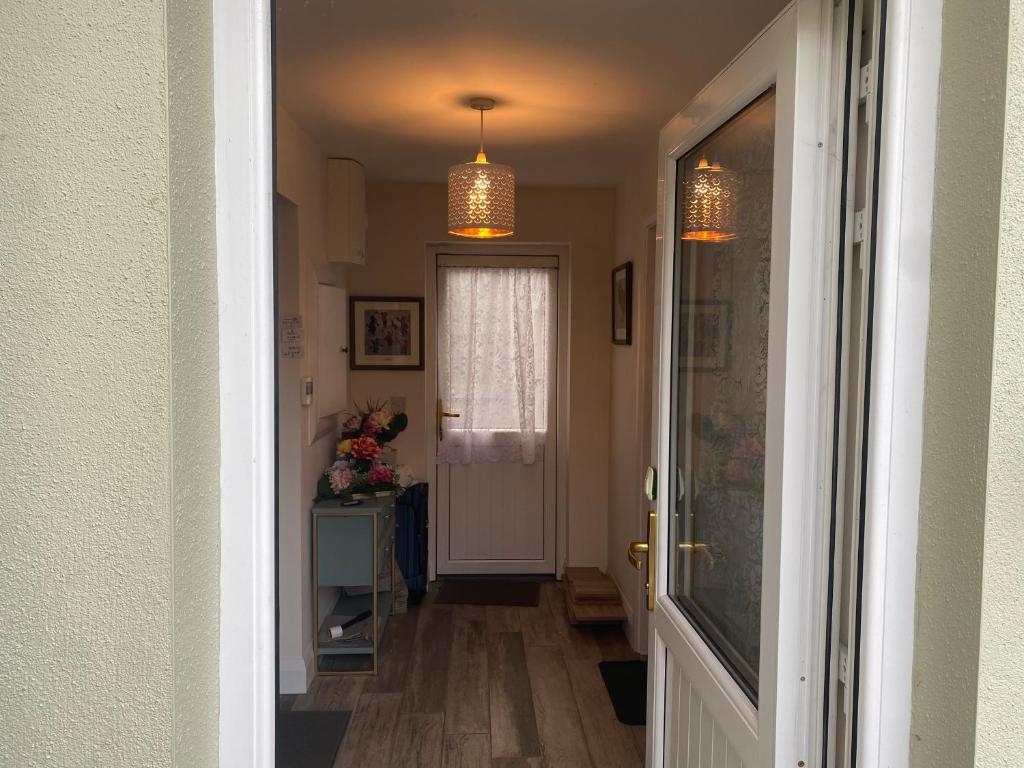 a hallway with a door leading to a room at Kilmactrasna Cottage in Carrickmacross
