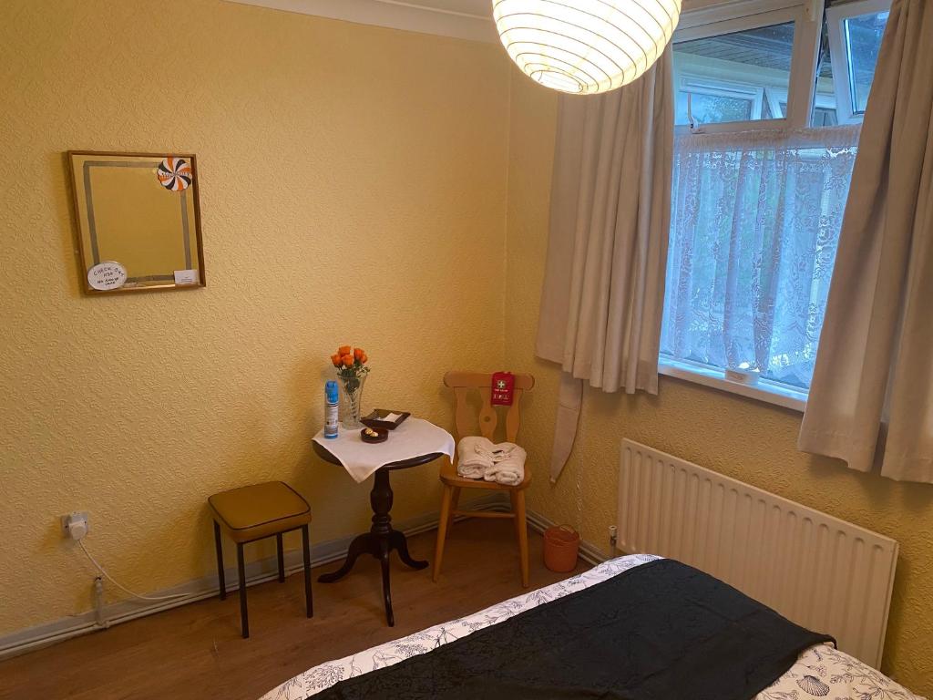 a bedroom with a bed and a table and a mirror at Kilmactrasna Cottage in Carrickmacross