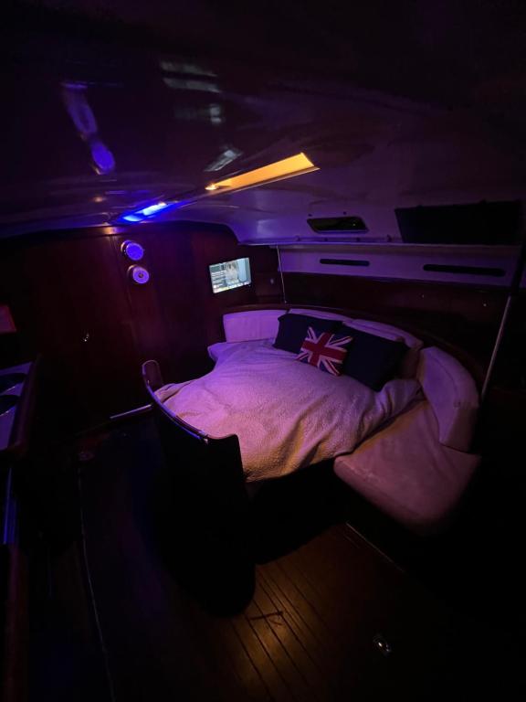 a bedroom with a bed in a small room at Carranade yacht in Torquay