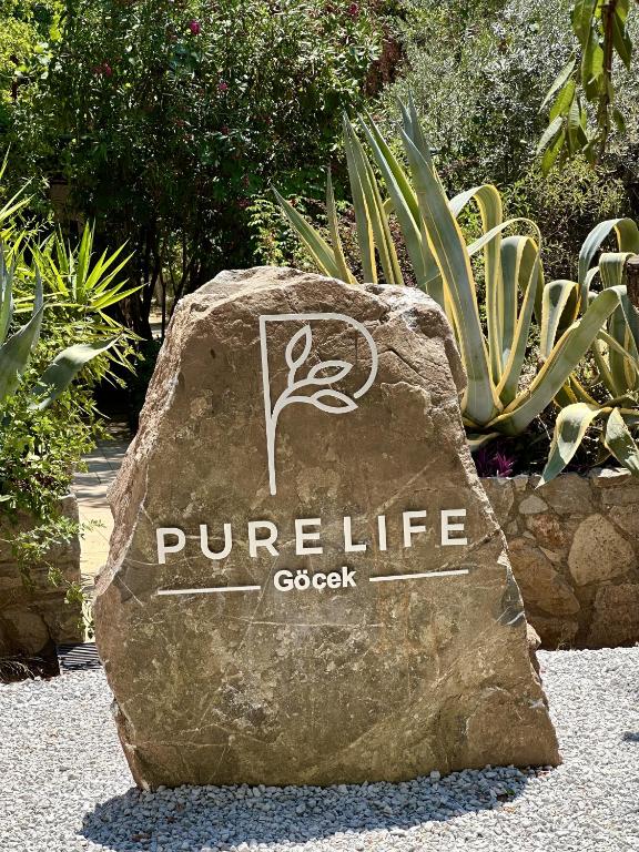 a rock with the words purple life on it at Pure Life Göcek in Gökçeovacık