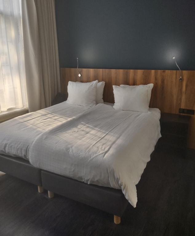 Postel nebo postele na pokoji v ubytování Hotel Zutphen