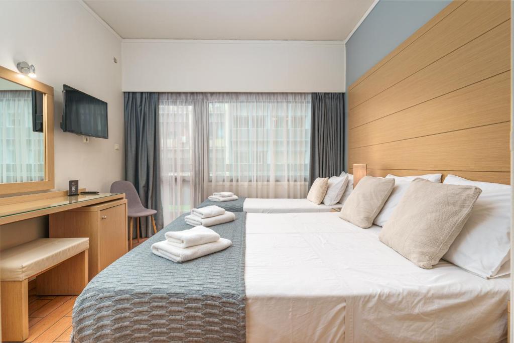 Posteľ alebo postele v izbe v ubytovaní Parnon Hotel