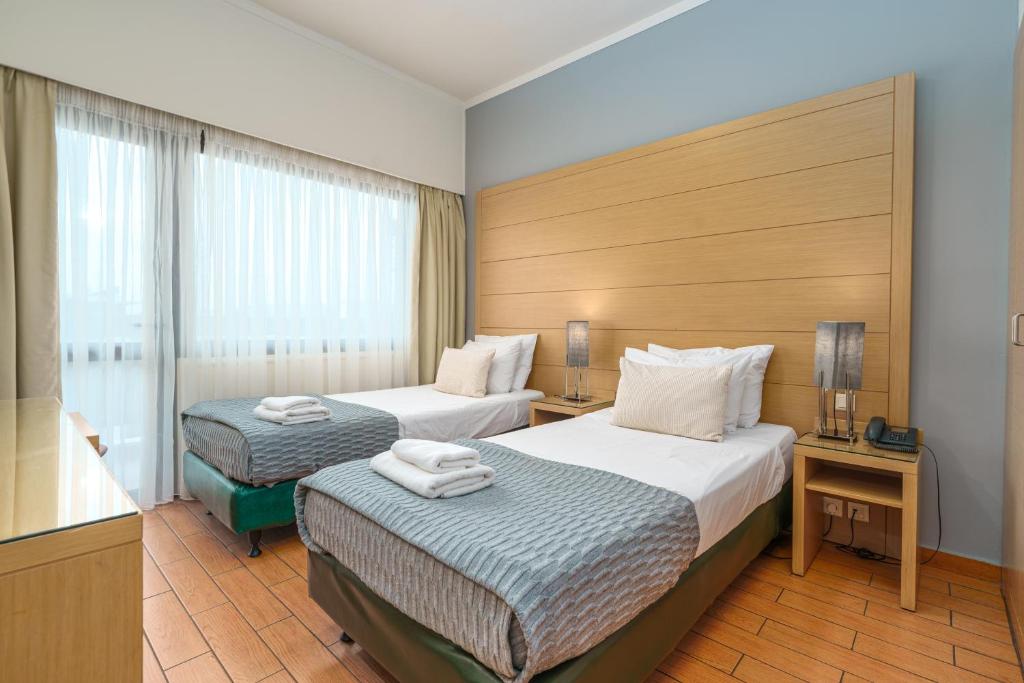 Posteľ alebo postele v izbe v ubytovaní Parnon Hotel