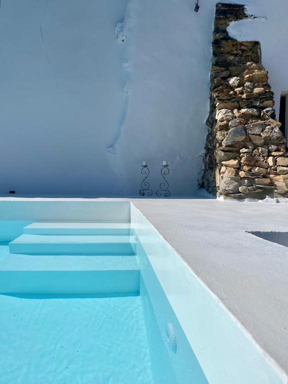 a blue swimming pool with stairs in a house at Alegrete Castle House by NaturAlegre in Alegrete