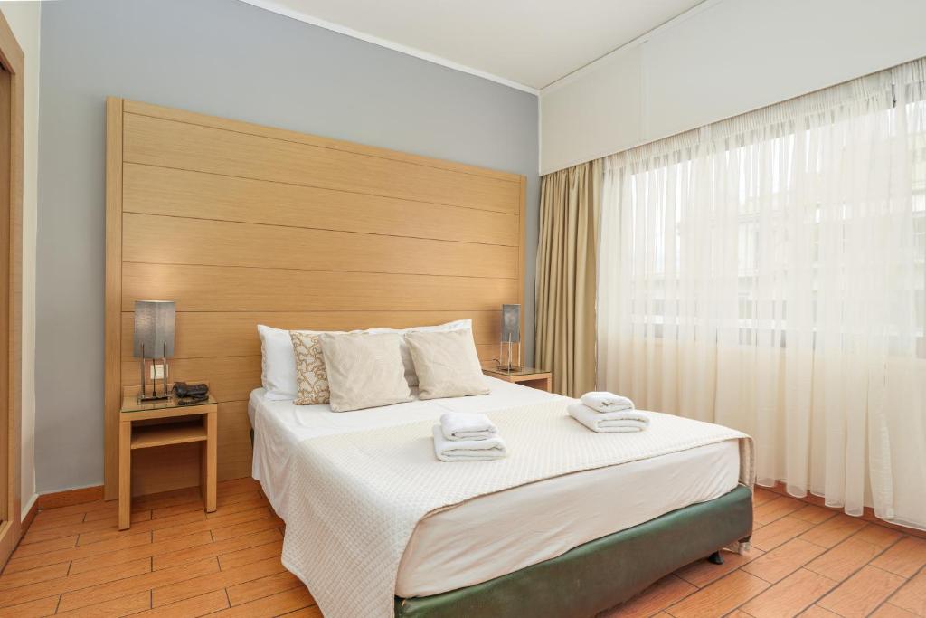 Posteľ alebo postele v izbe v ubytovaní Parnon Hotel