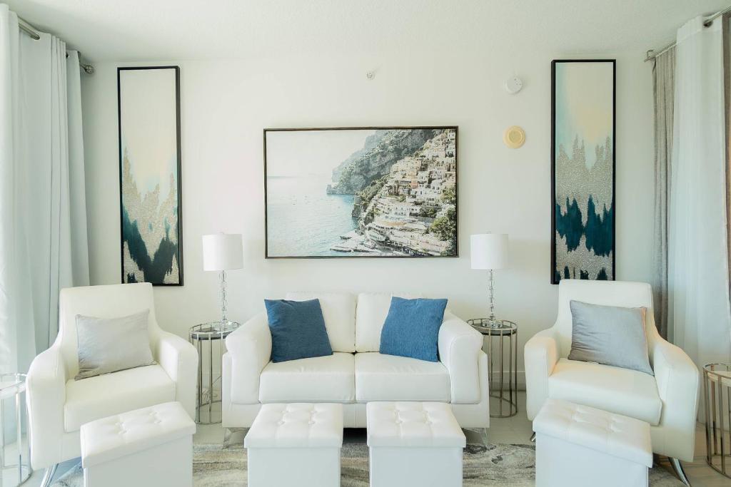 a living room with two chairs and a couch at The Serenity by the Sea Suite - Casa Costa 316S, 1 Bedroom and 2 Murphy beds close to Beach, Shops & Restaurants, Dog Friendly in Boynton Beach