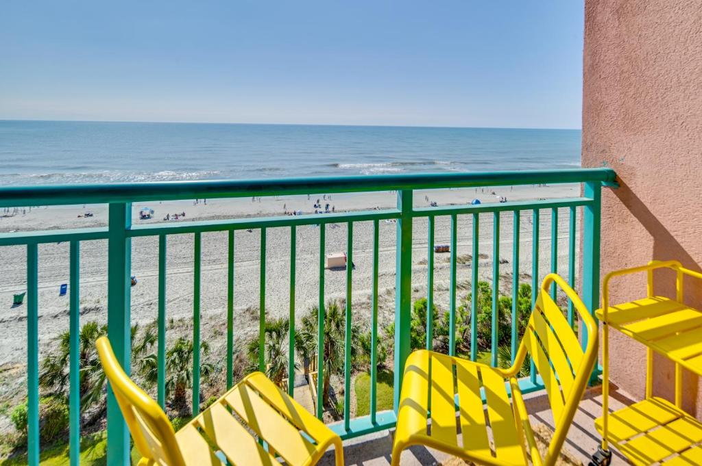 a balcony with yellow chairs and the beach at Myrtle Beach Oceanfront Condo w/ Pool & Lazy River in Myrtle Beach