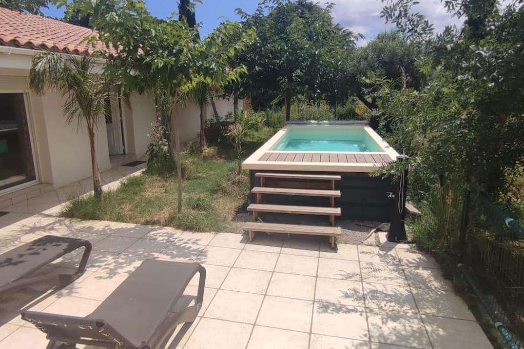 - une piscine dans une cour avec 2 chaises et une table dans l'établissement Mas Picton Maison 4 chambres dans Mas piscine proche mer, à Argelès-sur-Mer