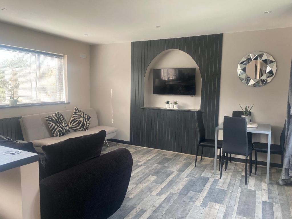 a living room with a couch and a table at Rivendell spacious two bedroom 1st floor flat in Kent