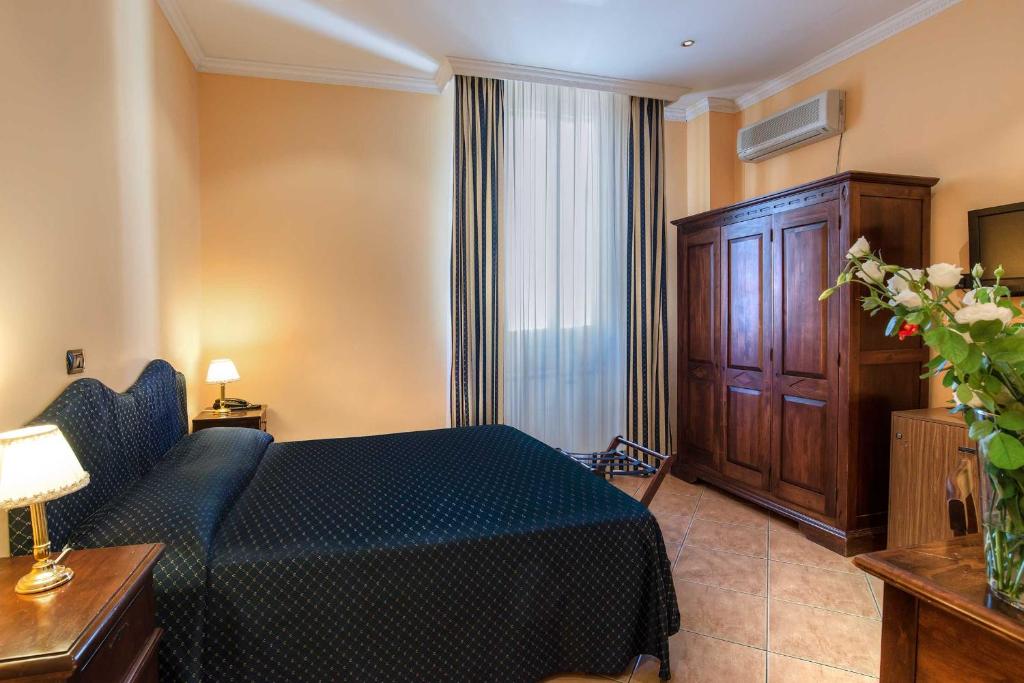 Postel nebo postele na pokoji v ubytování Hotel Caracciolo