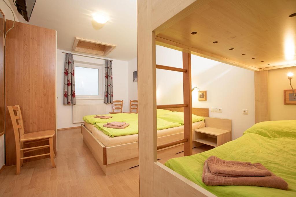a bedroom with two beds and a mirror at Chalet Central Top CC 6 in Königsleiten