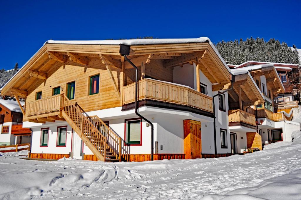a house in the snow with a balcony at Chalet Central Top CC 7 in Königsleiten