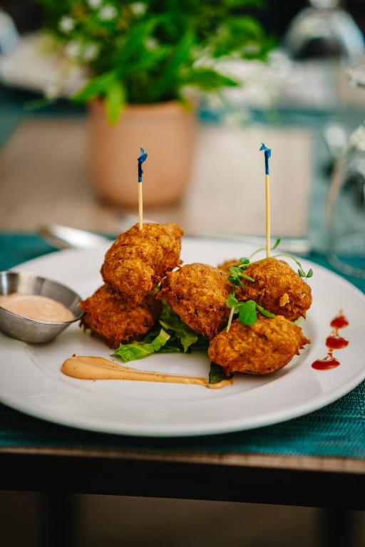 a plate of food with meatballs on a table at Coconut Court Beach Hotel in Bridgetown