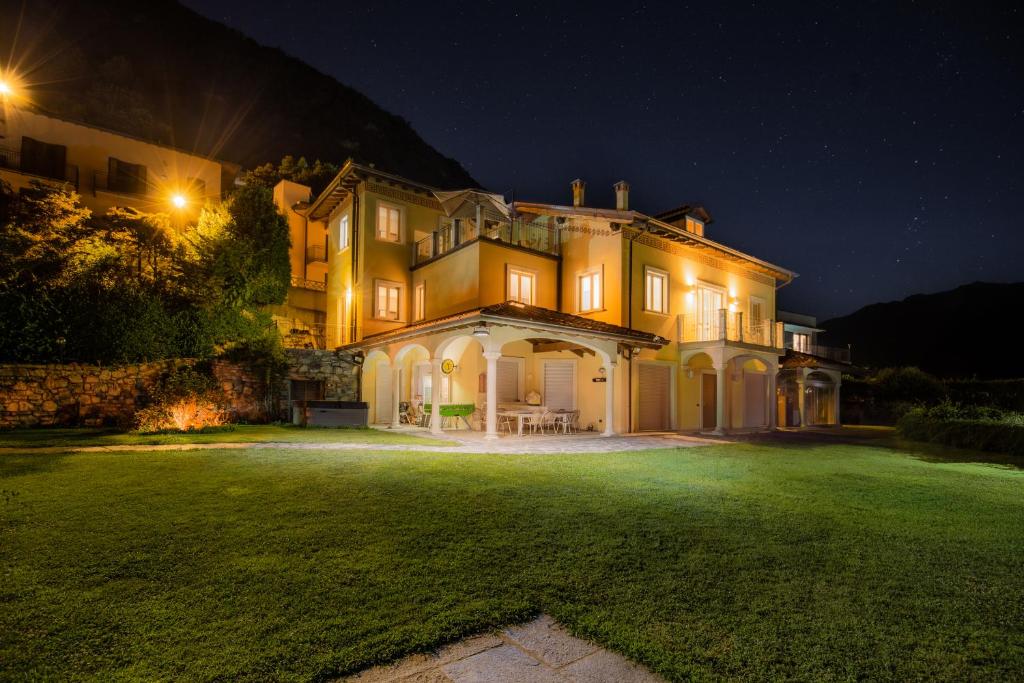a large house with a yard at night at Luxury Villa Laglio in Laglio