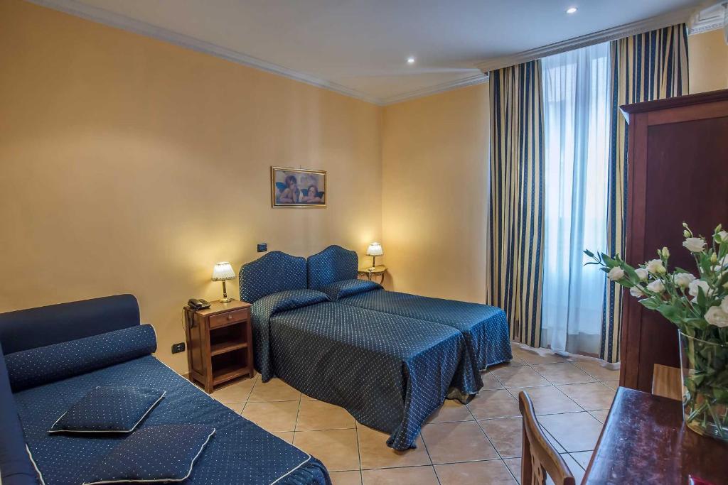 Postel nebo postele na pokoji v ubytování Hotel Caracciolo