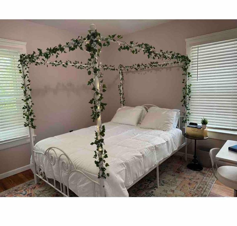 a bedroom with a bed with a ivy frame at Garden Whisper Cozy Chamber in Cleveland