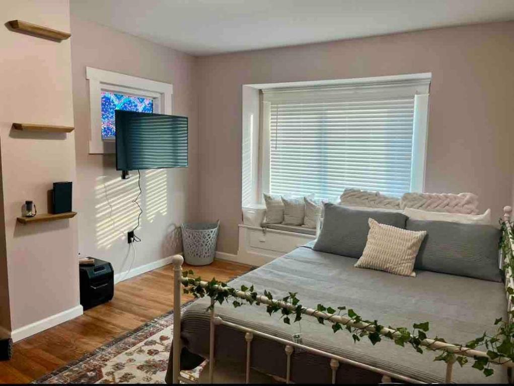 a living room with a couch and a window at Stained Glass Serenity Suite in Cleveland
