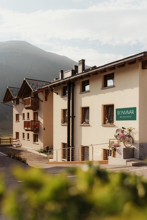 a building with a bike parked in front of it at Bonvivar - Mountain Guesthouse in Livigno