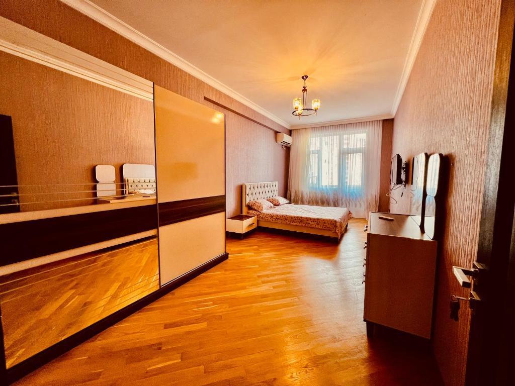 a room with a living room with a large refrigerator at Secrets Apartment in Baku