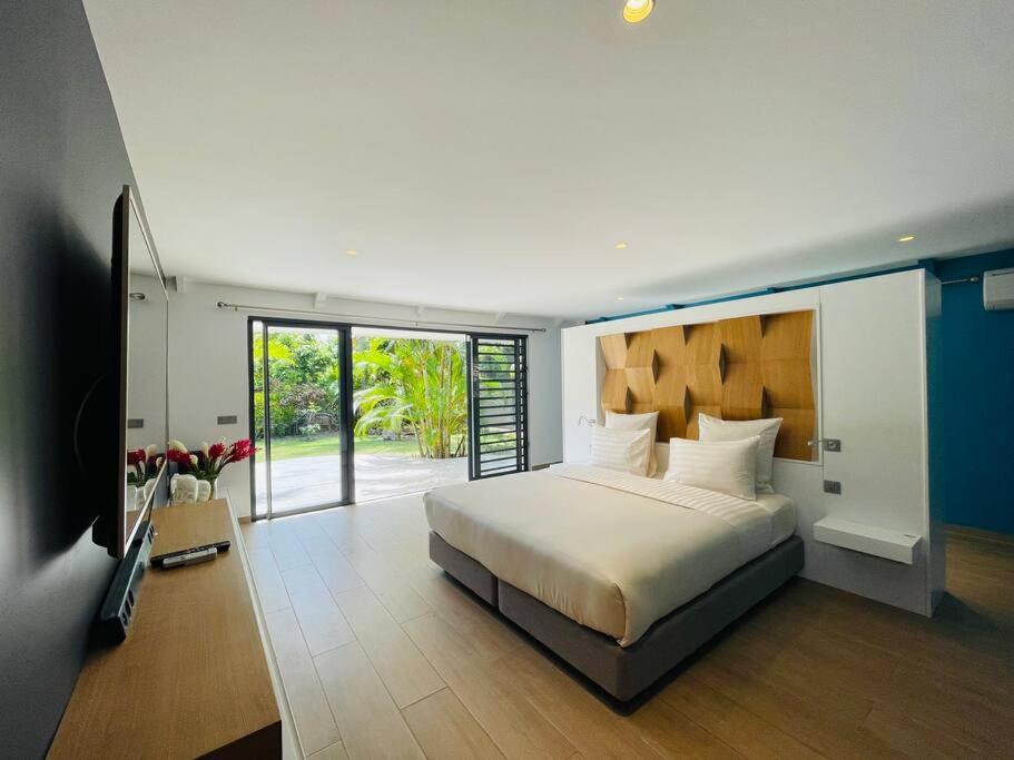 a bedroom with a bed and a television in it at Villa Moana Reva in Bora Bora