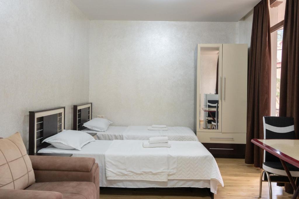 Postel nebo postele na pokoji v ubytování Hotel Lile • სასტუმრო ლილე