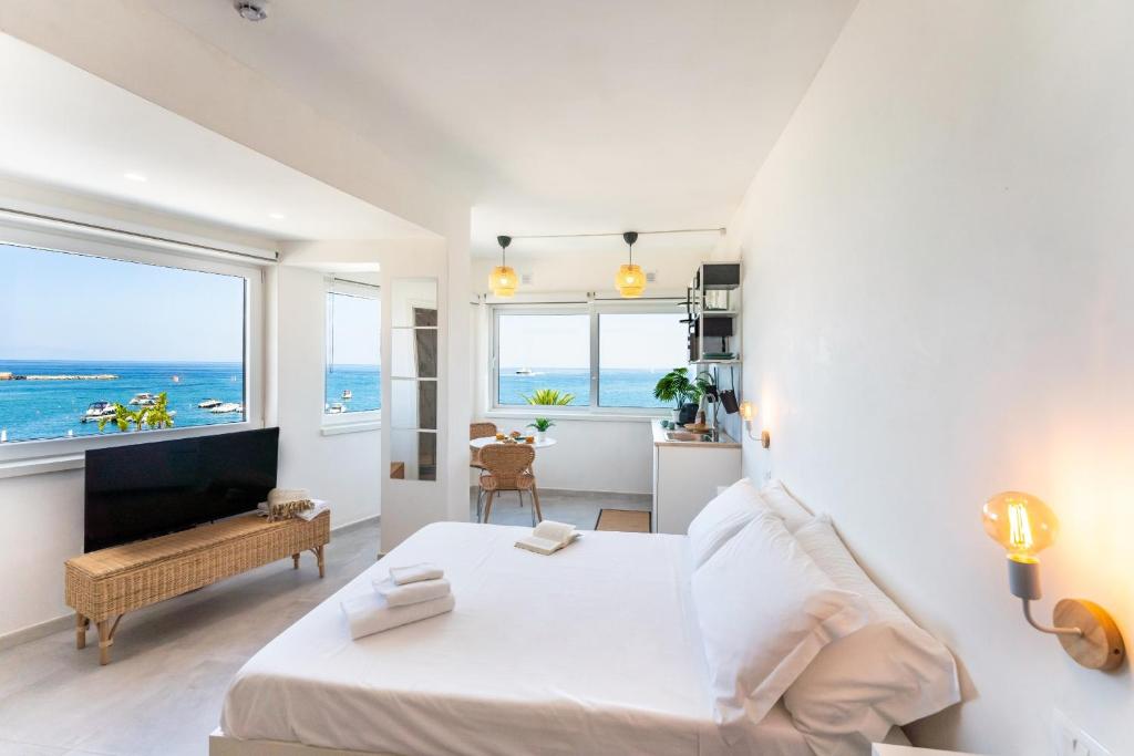 a bedroom with a bed and a view of the ocean at Suite The Mana Vista Mare in Centro - Casamicciola Terme in Ischia