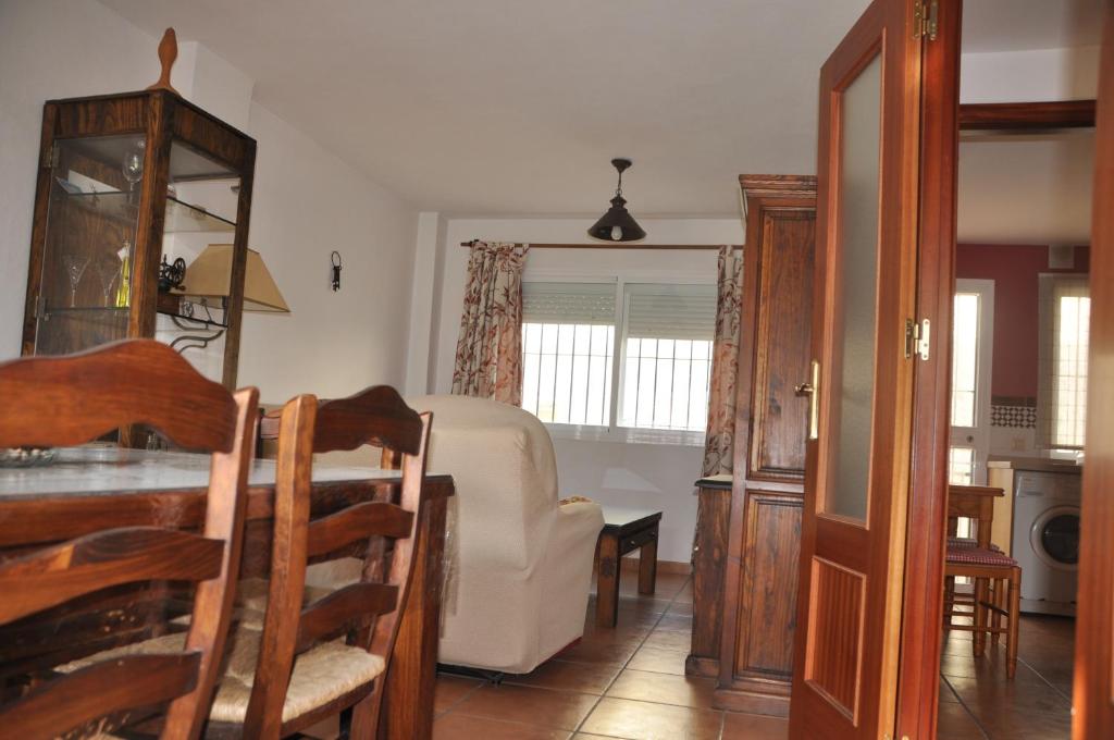 un soggiorno con divano, tavolo e sedie di Casa Rojas a Tarifa
