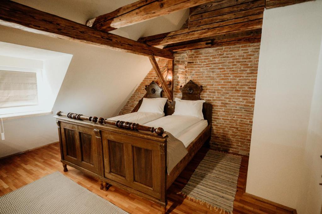 a bedroom with a bed in a brick wall at Casa Weber in Sighişoara
