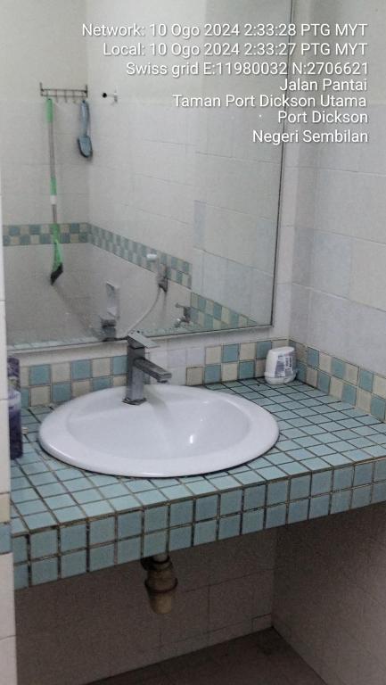 a bathroom counter with a sink and a mirror at Apartment Seaview beach pd in Port Dickson