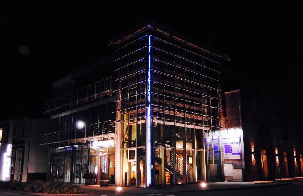 a building with scaffolding on the side of it at night at Art Hotel Ahlen in Ahlen