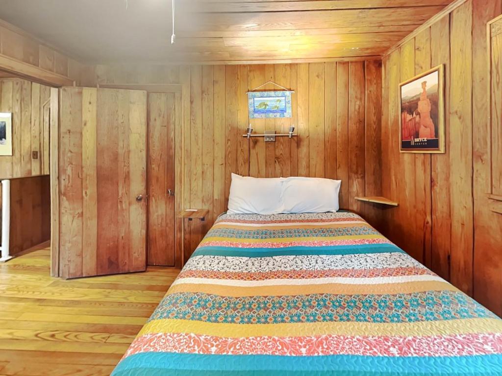 a bedroom with a bed in a wooden room at Ski Shore in Swanton