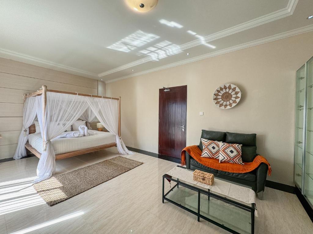 Postel nebo postele na pokoji v ubytování Merdeka Kuta Guesthouse
