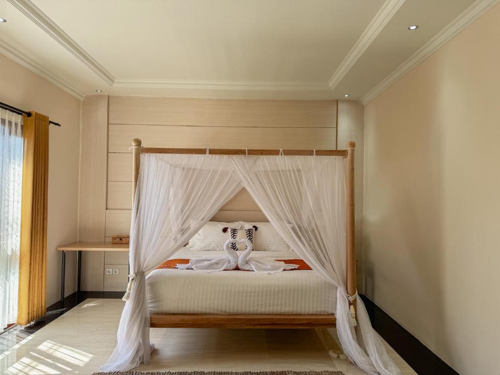 Postel nebo postele na pokoji v ubytování Merdeka Kuta Guesthouse