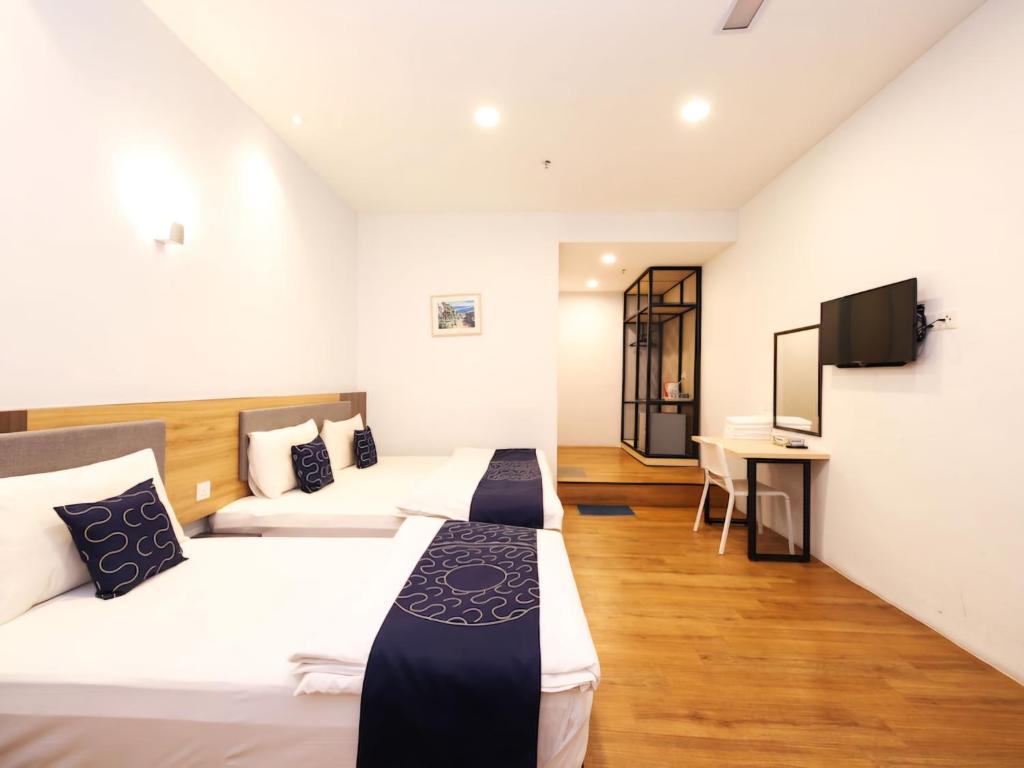 Postel nebo postele na pokoji v ubytování Agape Hotel Selayang