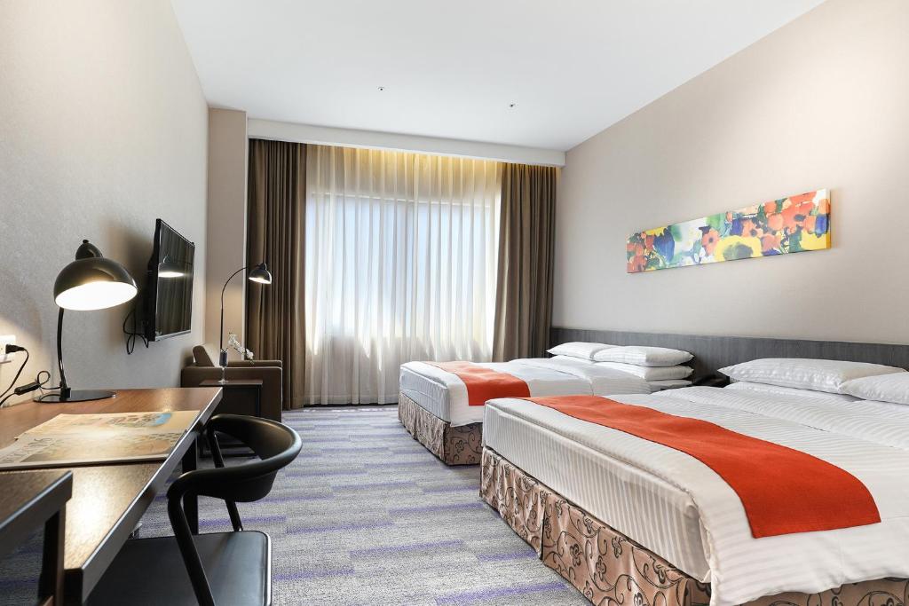Postel nebo postele na pokoji v ubytování Hoya Resort Hotel Kaohsiung