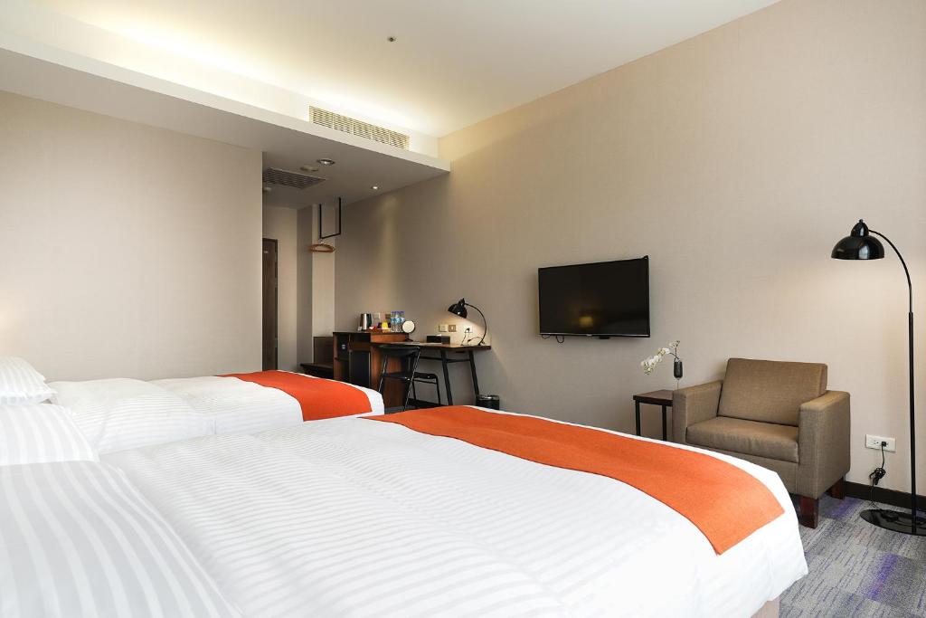 Postel nebo postele na pokoji v ubytování Hoya Resort Hotel Kaohsiung