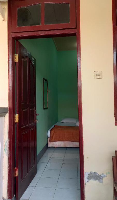 Postel nebo postele na pokoji v ubytování Hotel Kawsar Syariah