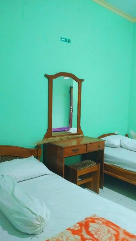 Postel nebo postele na pokoji v ubytování Hotel Kawsar Syariah