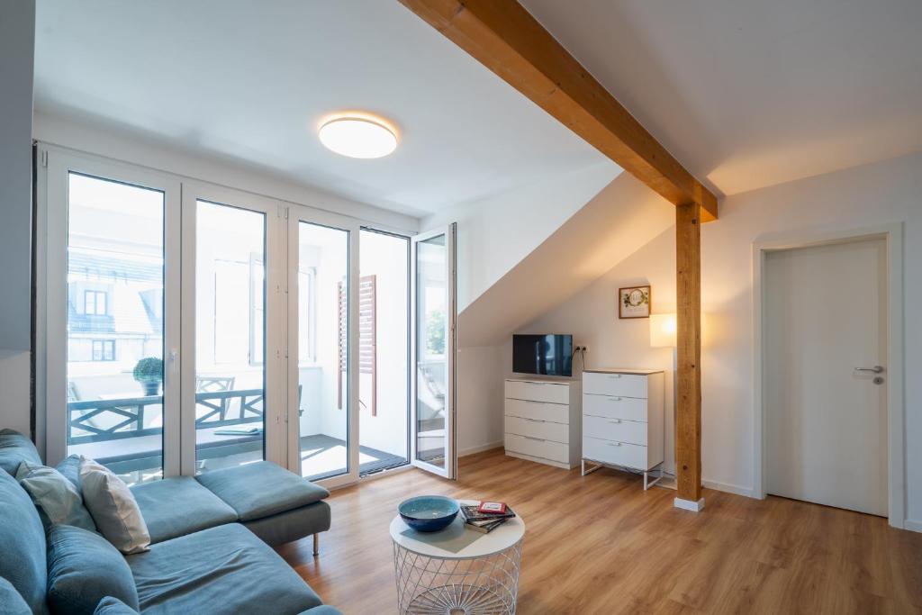a living room with a couch and a table at App 8o großer Tag am Meer mit Wasserblick in Dranske