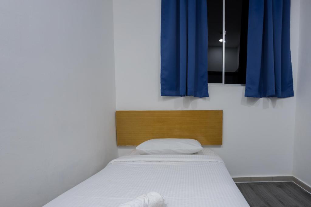Postel nebo postele na pokoji v ubytování Nunuk Ragang Hotel