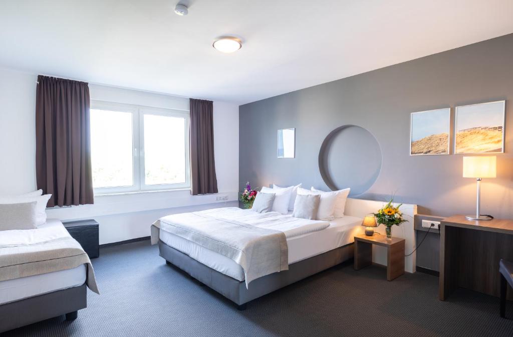 Postel nebo postele na pokoji v ubytování Hotel Aviva