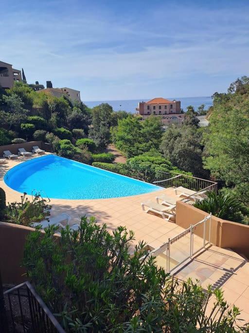 a large swimming pool sitting on top of a house at Maison bord de mer - piscine - in Théoule-sur-Mer